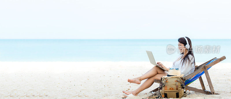 Lifestyle freelance woman using laptop working and relax on the beach.  Asian people on canvas bed beach success and together your work pastime and meeting conference